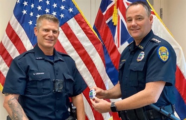Chief giving an officer his badge
