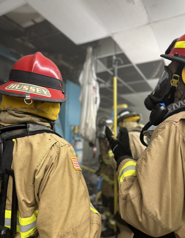 Firefighters assess the scene at the structure fire.