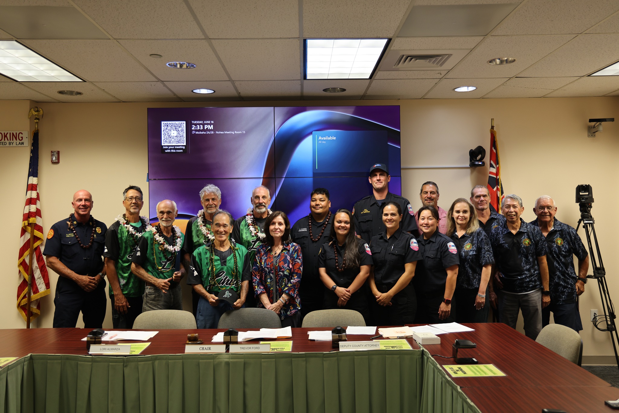 Members of the LĪhuʻe Aʻs senior softball team are recognized for their lifesaving actions alongside Kauaʻi Fire Department Chief Michael Gibson.