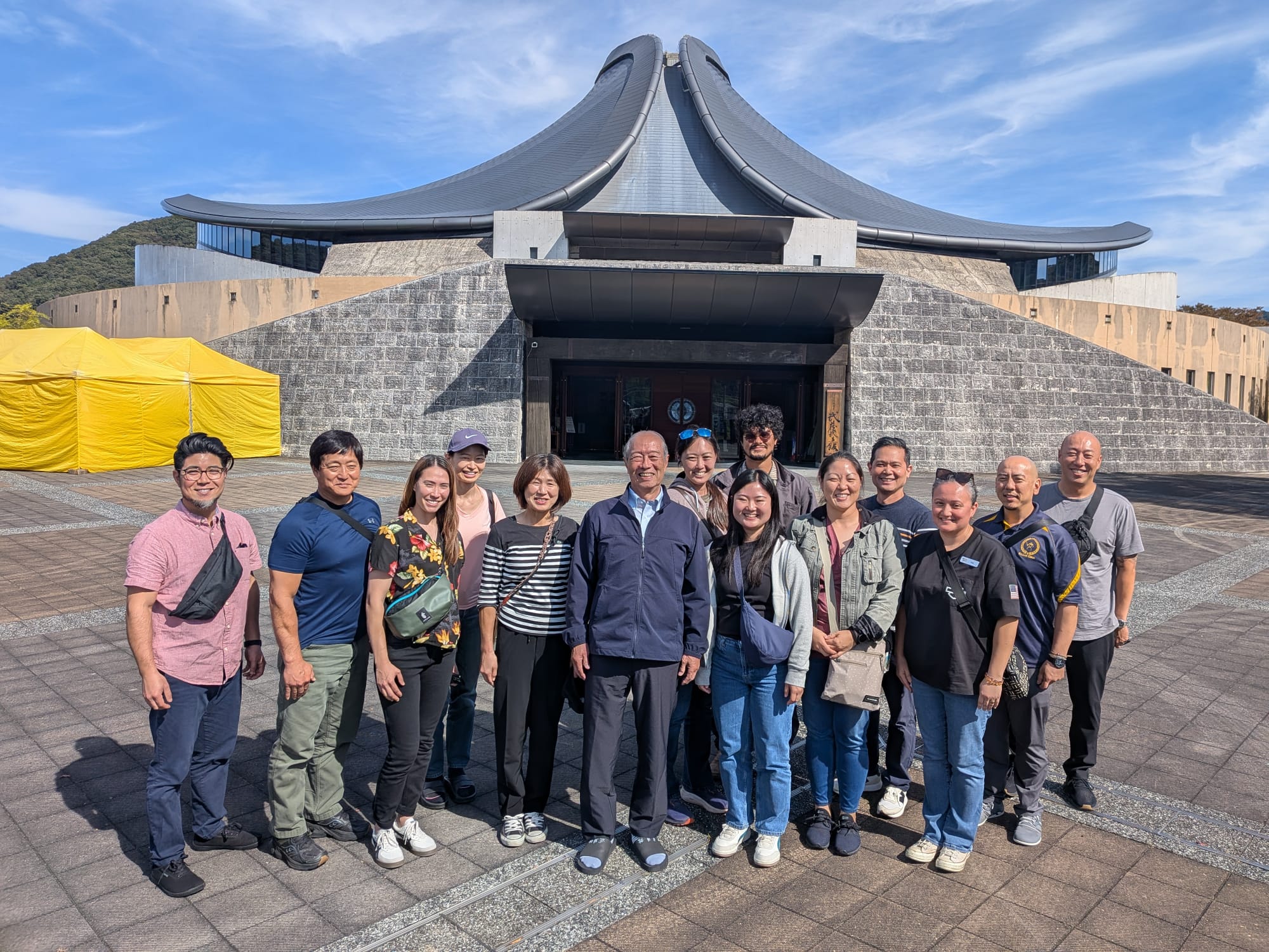 The Kaua‘i and Hawai‘i delegation in front of the Miyamoto Musashi Budokan in Mimasaka, joined by Naofumi Hara sensei and Miki Tadamasa sensei.