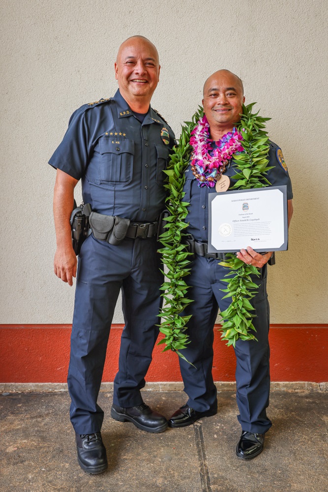 Chief Ke congratulates Officer Arnold Cayabyab on his retirement and recognition as Employee of the Month for his outstanding service and dedication to public safety. 