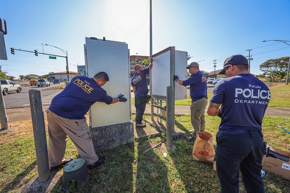 Officers cleaning graffiti