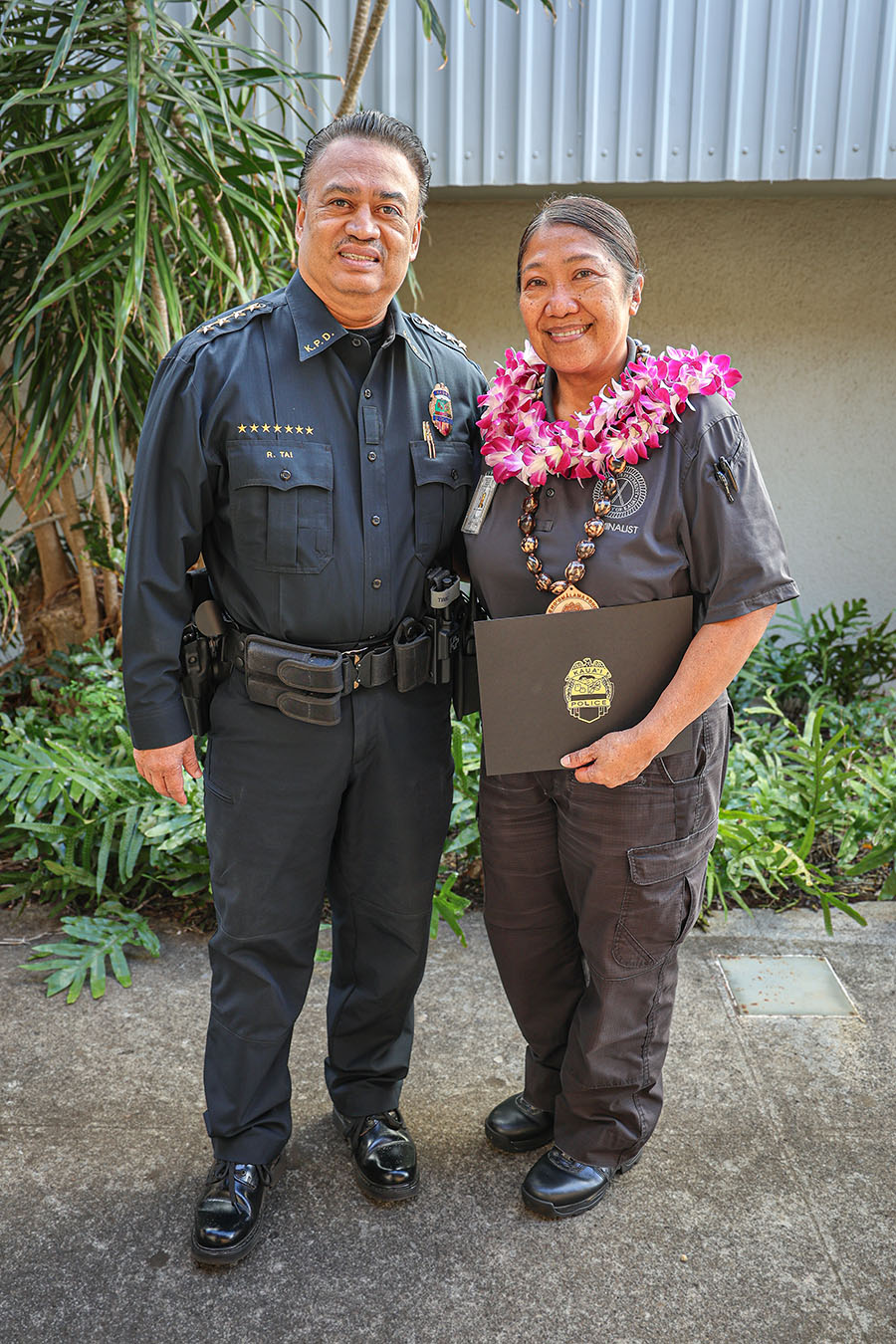 Chief of Police Rudy Tai (left) presented the KPD October Employees of the Month award to Michaelyn Etrata (right) and Dr. Christian Vlautin (not pictured).