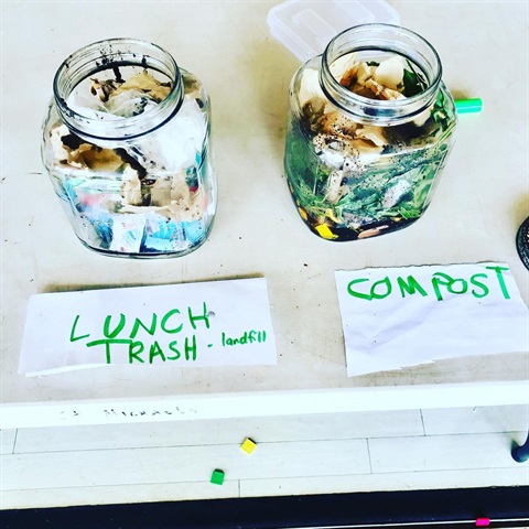 Two jars. One with landfill items, and one with compostable items
