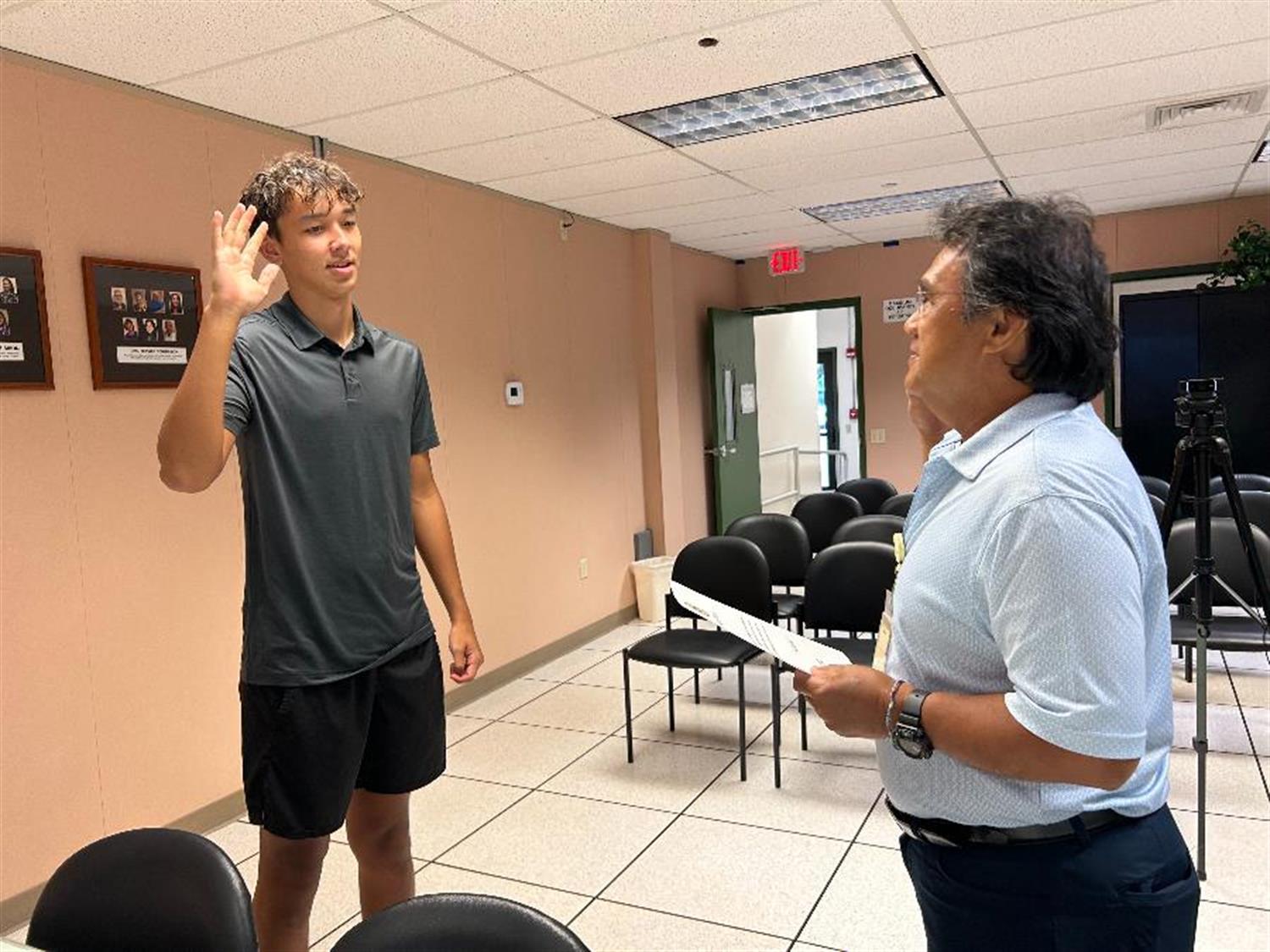 Swede Sandblom (left), a senior at Waimea High School, being sworn in by Eddie Topenio, Administrative Assistant to the Office of the County Clerk at Monday's Charter Review Commission Meeting.